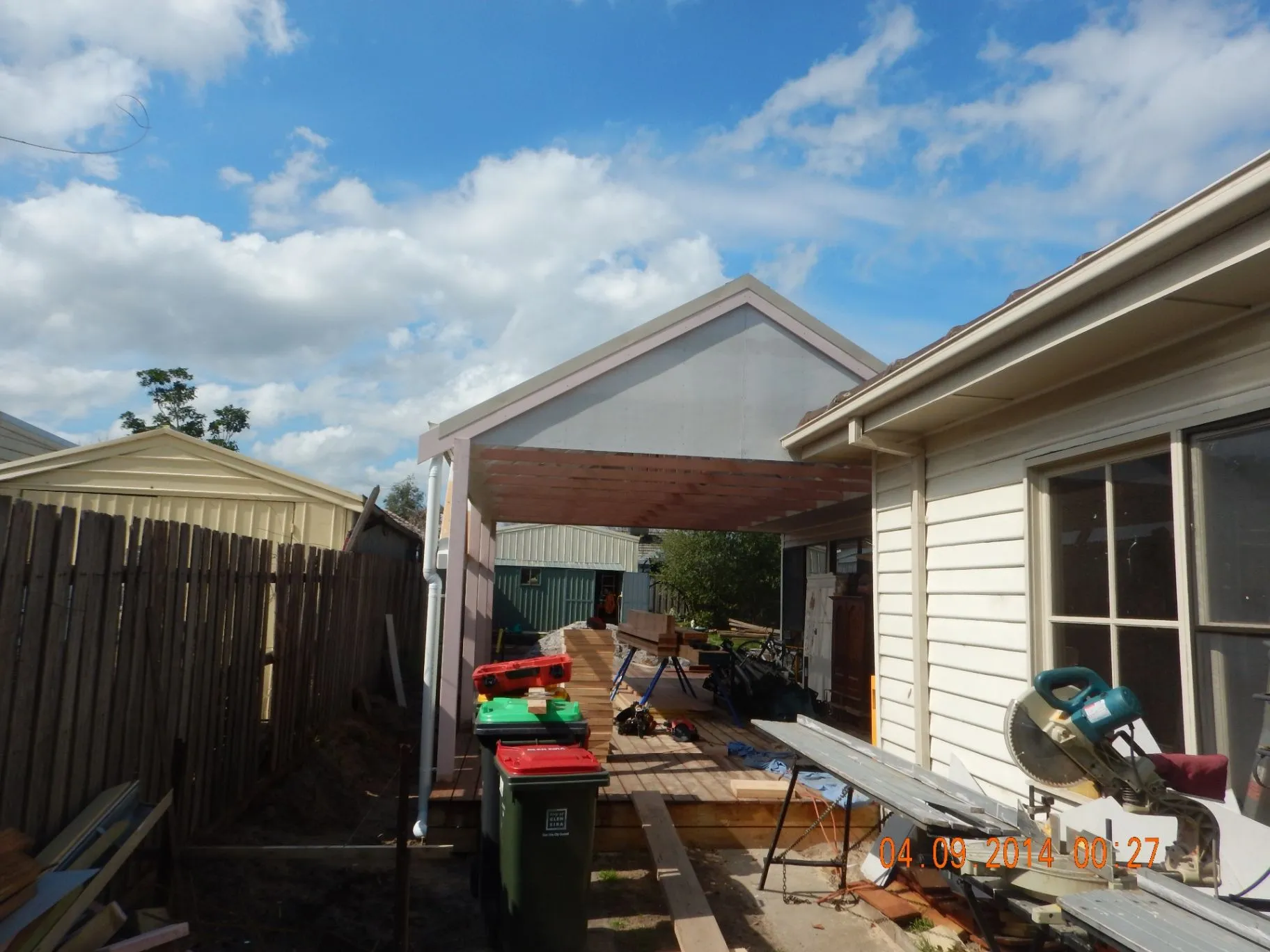 Bentleigh East timber rear deck and carport connection taking shape beside the home