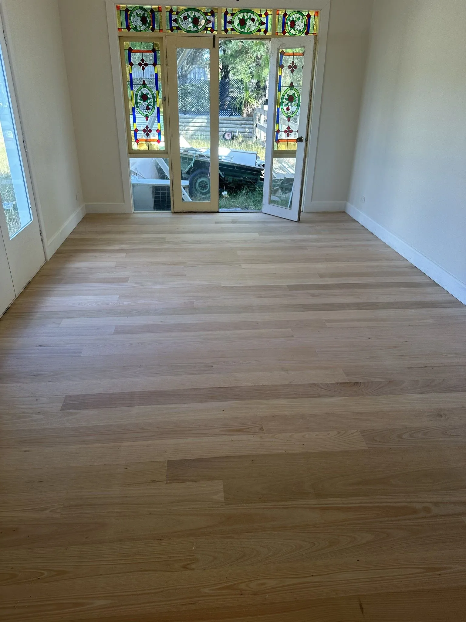Engineered oak floor and retained stained glass in the Taylors Court renovation, Kyneton.