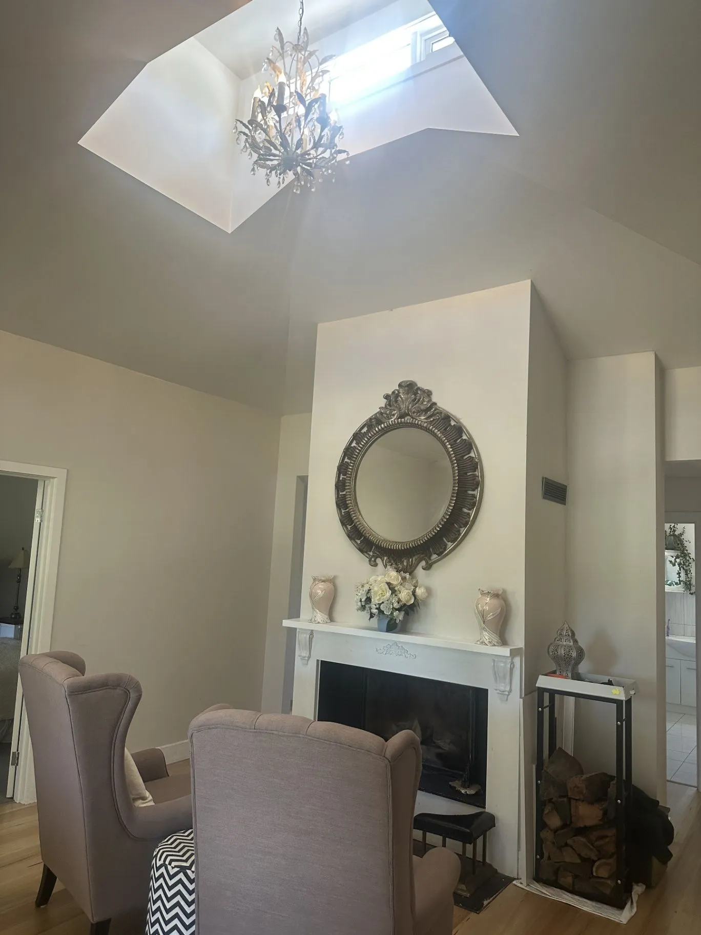 Living room with fireplace and skylight in the completed Taylors Court renovation, Kyneton.